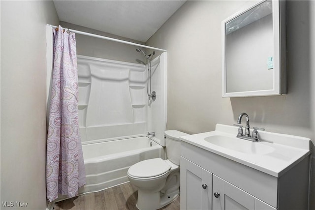 full bathroom with vanity, wood finished floors, shower / bath combination with curtain, and toilet