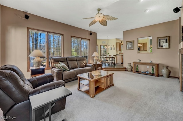 carpeted living area featuring a ceiling fan