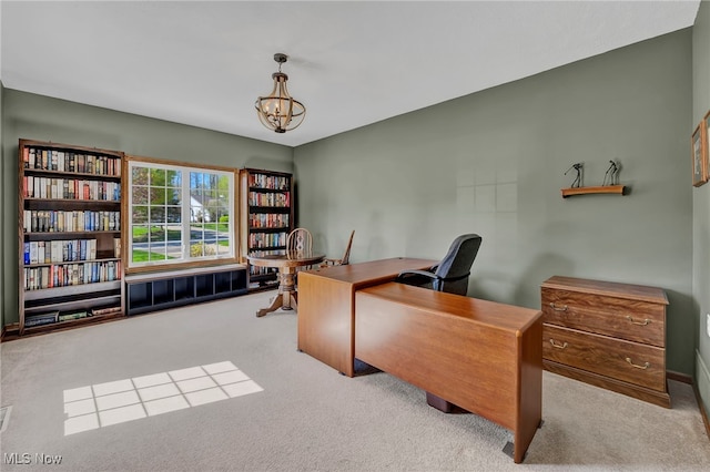 office with carpet flooring and a chandelier