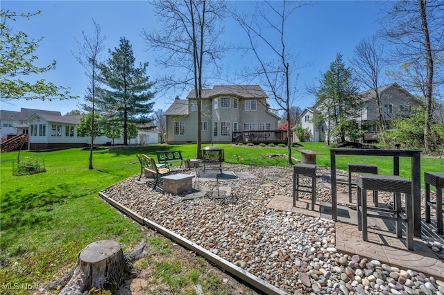 view of yard featuring a residential view, a patio, and a deck