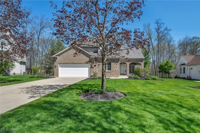 traditional-style house with concrete driveway, brick siding, an attached garage, and a front lawn