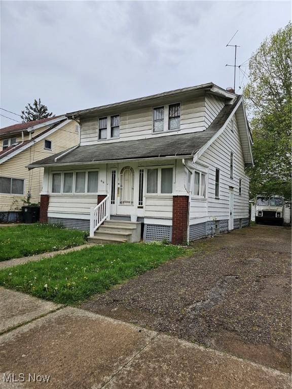 multi unit property featuring driveway and a shingled roof
