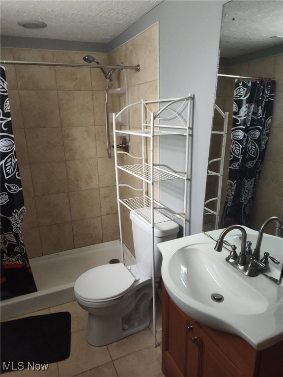 916 Mercer Ave, Akron, OH 44320 - bathroom with a textured ceiling, vanity, tile patterned flooring, toilet, and a tile shower