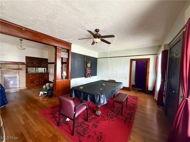 207 E Crown Ave, Pennsboro, WV 26415 - game room with ceiling fan, a fireplace, a textured ceiling, billiards, and wood finished floors