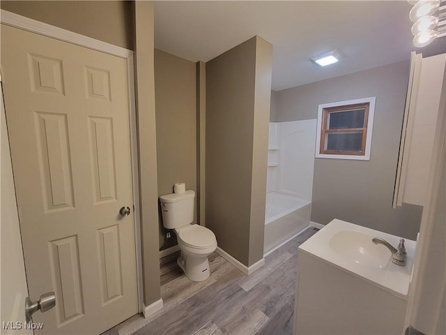 full bathroom featuring vanity, tub / shower combination, wood finished floors, and toilet