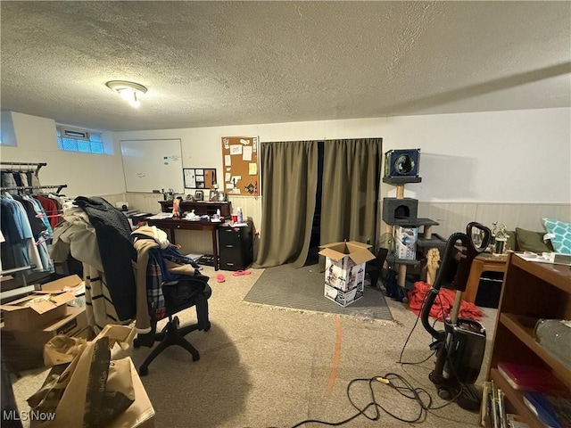 home office featuring carpet floors and a textured ceiling