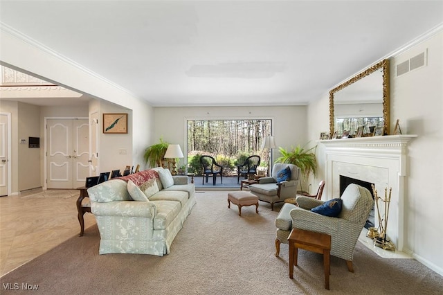 living area featuring a premium fireplace, baseboards, visible vents, and ornamental molding