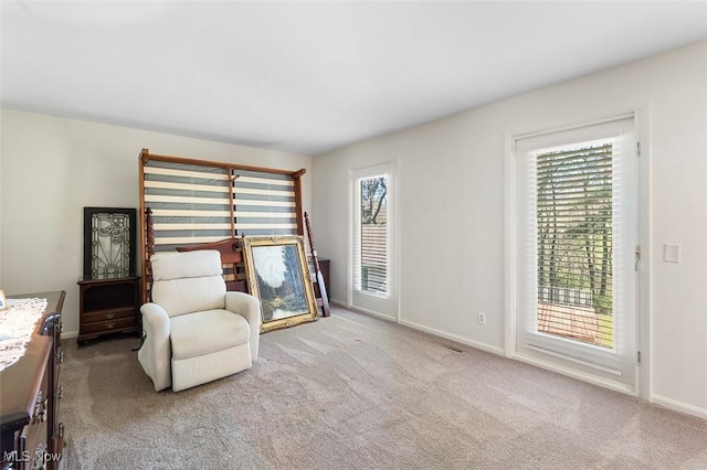 sitting room featuring carpet flooring and baseboards
