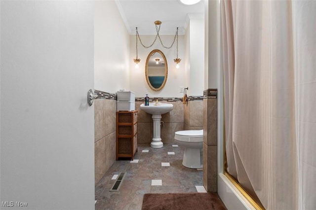 bathroom featuring visible vents, ornamental molding, toilet, tile walls, and a shower with curtain