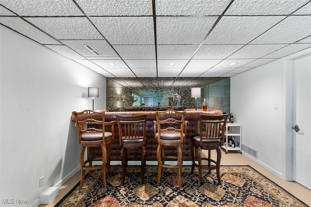 bar featuring a paneled ceiling, visible vents, a dry bar, baseboards, and recessed lighting