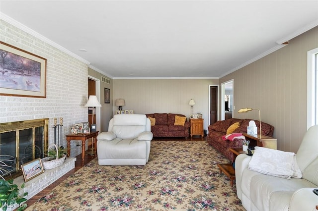 living room with a brick fireplace, visible vents, ornamental molding, and wood finished floors