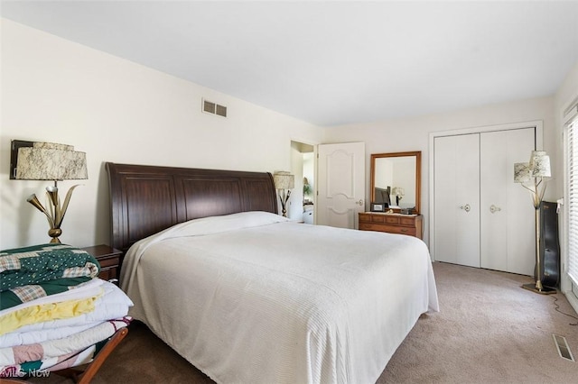 bedroom with visible vents, a closet, and light carpet