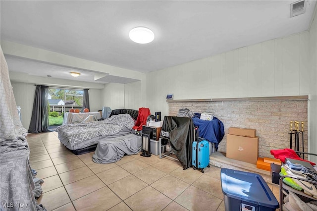 tiled bedroom with visible vents and access to outside