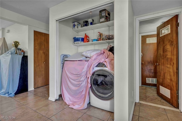 washroom featuring visible vents, laundry area, and washer / clothes dryer
