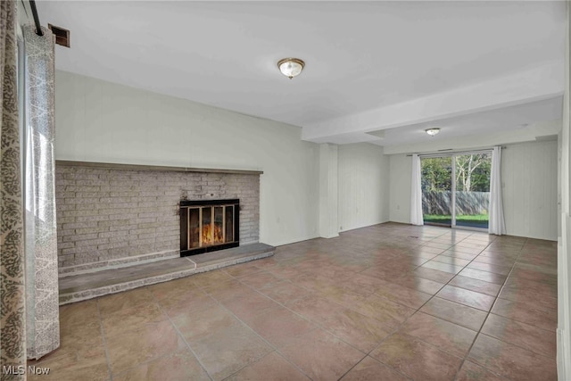 unfurnished living room with tile patterned floors and a fireplace