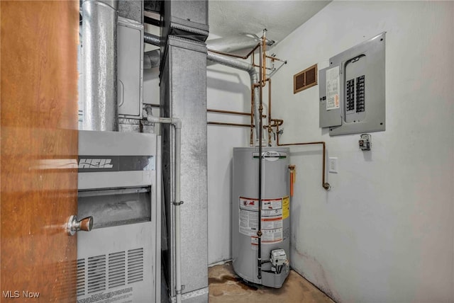utilities featuring heating unit, visible vents, gas water heater, and electric panel