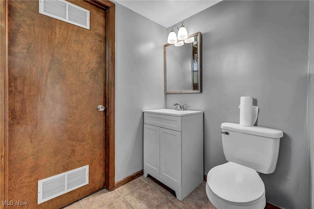 bathroom with visible vents, tile patterned floors, toilet, and vanity