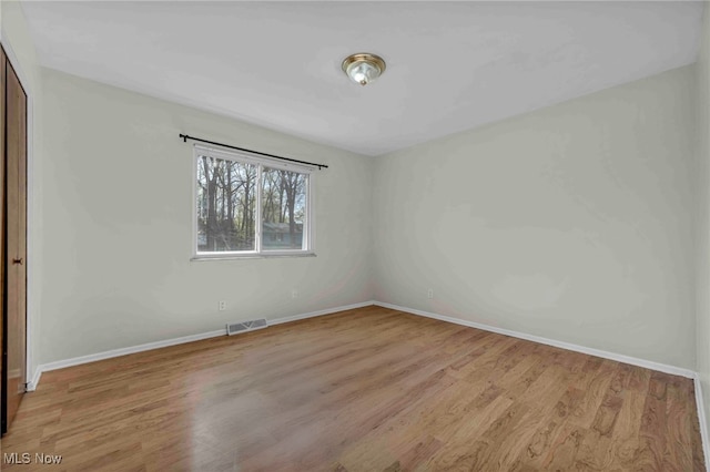 unfurnished bedroom with visible vents, baseboards, a closet, and light wood-type flooring