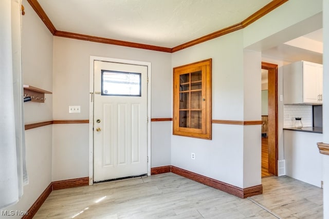 3860 Colony Rd, South Euclid, OH 44118 - entryway with crown molding, baseboards, and light wood-style floors
