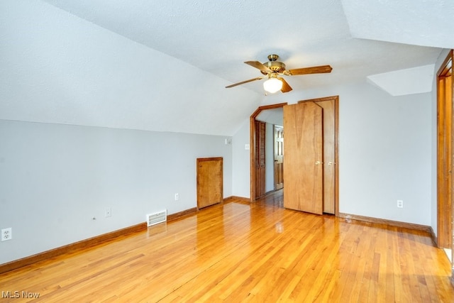 3860 Colony Rd, South Euclid, OH 44118 - additional living space featuring light wood finished floors, a ceiling fan, baseboards, lofted ceiling, and visible vents