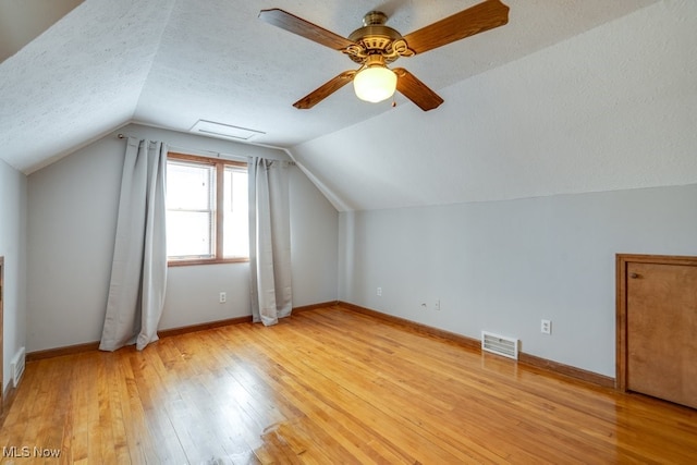 3860 Colony Rd, South Euclid, OH 44118 - additional living space with visible vents, lofted ceiling, light wood-style floors, baseboards, and a ceiling fan