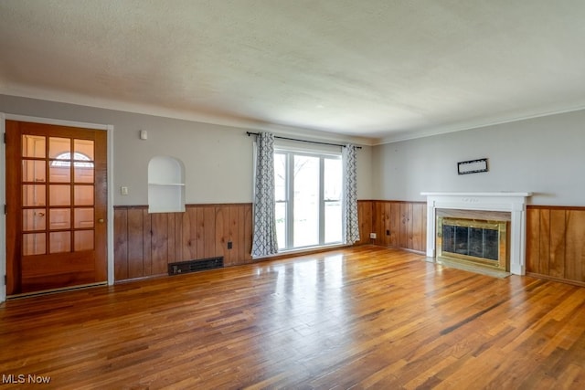 3860 Colony Rd, South Euclid, OH 44118 - unfurnished living room featuring a fireplace with flush hearth, wood finished floors, and a wainscoted wall