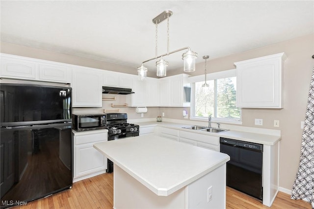 kitchen featuring a sink, light countertops, white cabinets, black appliances, and under cabinet range hood