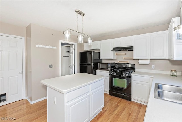 kitchen with white cabinets, black appliances, light wood finished floors, and under cabinet range hood
