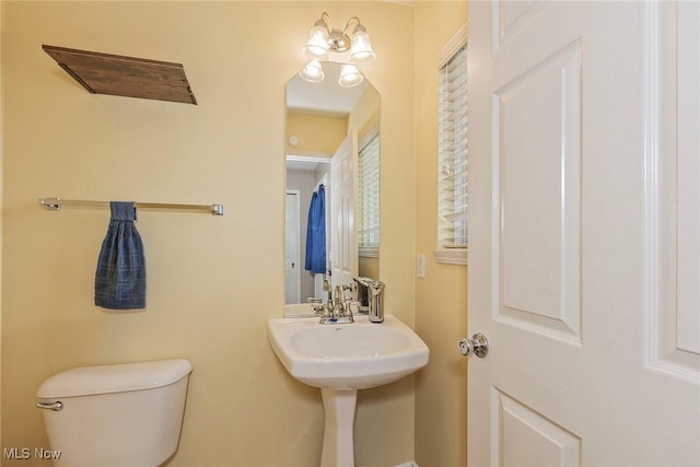 half bathroom featuring toilet