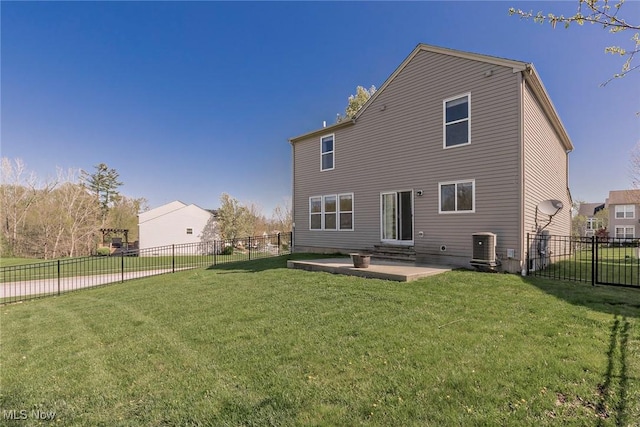 back of property featuring central air condition unit, a fenced backyard, a lawn, and a patio area
