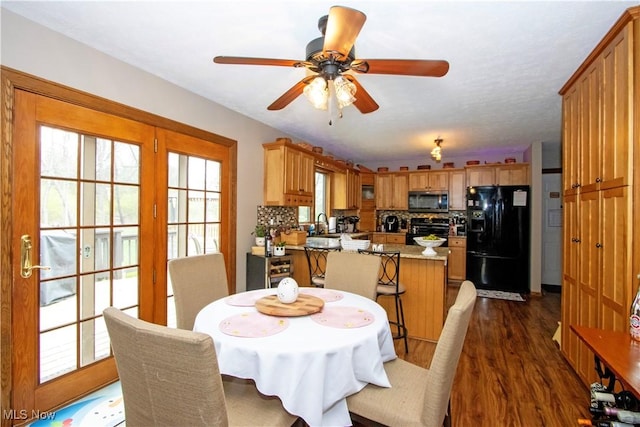 dining area featuring a ceiling fan and dark wood-style flooring