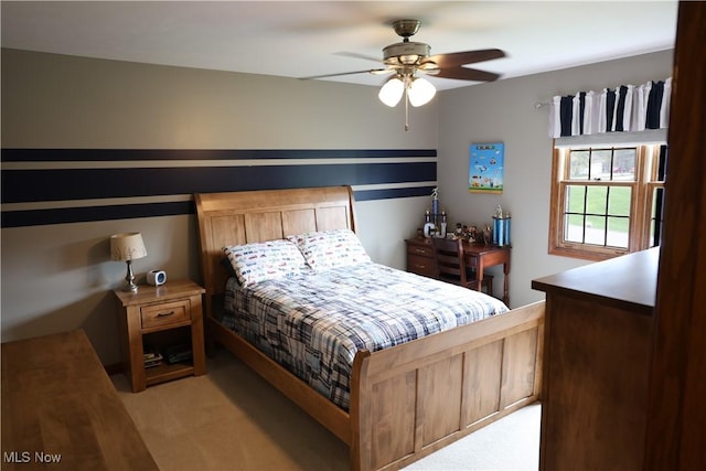 bedroom featuring a ceiling fan and light colored carpet