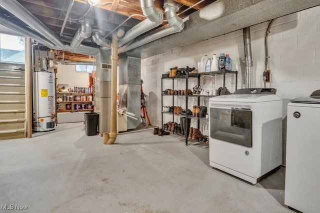 below grade area featuring heating unit, gas water heater, and washing machine and clothes dryer