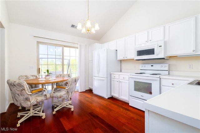 kitchen with visible vents, dark wood-style floors, an inviting chandelier, white appliances, and white cabinetry