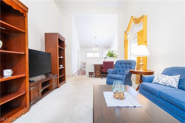 living room with carpet and lofted ceiling