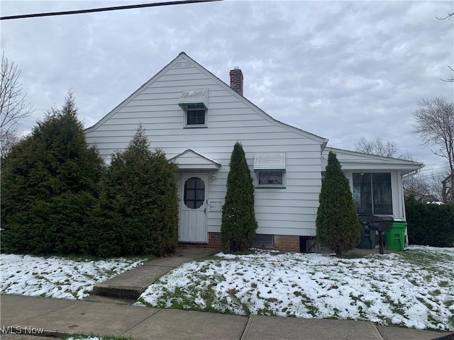 view of front of home featuring a chimney