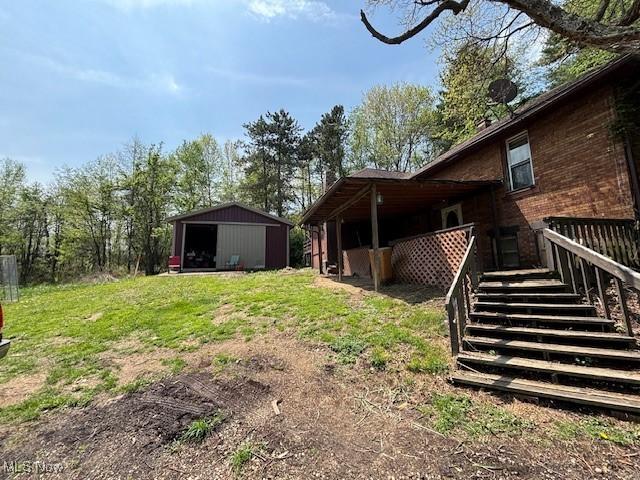 view of yard featuring an outdoor structure, an outbuilding, and stairway