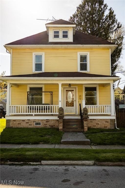 american foursquare style home with a porch