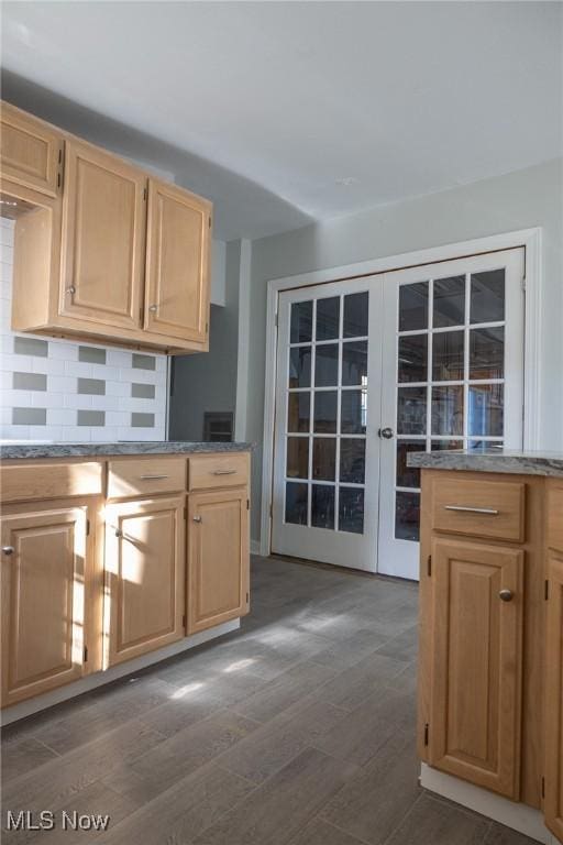 kitchen featuring light brown cabinets, backsplash, and dark wood-style flooring