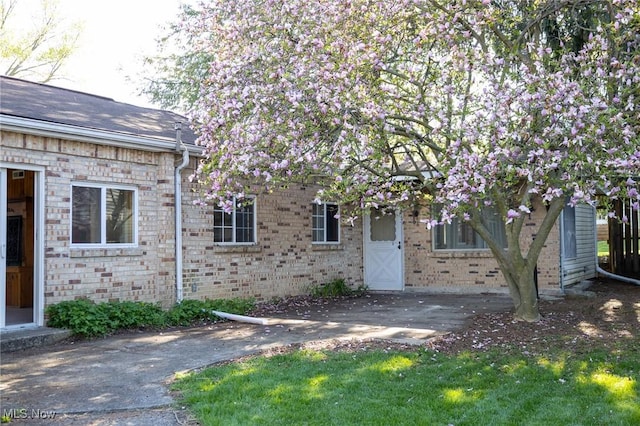 exterior space featuring brick siding