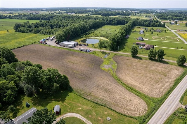 birds eye view of property featuring a water view and a rural view