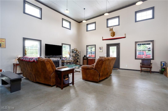 living room with a high ceiling, a wealth of natural light, and finished concrete flooring