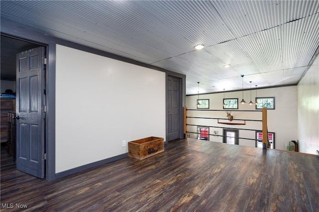 interior space featuring baseboards and wood finished floors