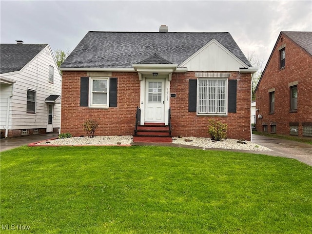 12008 Darlington Ave, Garfield Heights, OH 44125 - view of front of house with entry steps, roof with shingles, and brick siding