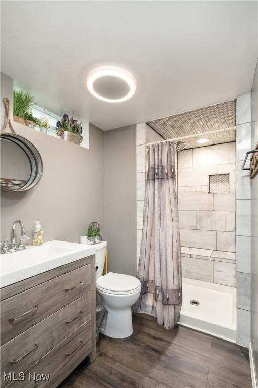 4160 Cambridge Ave, Lorain, OH 44053 - full bathroom with vanity, a stall shower, toilet, and wood finished floors