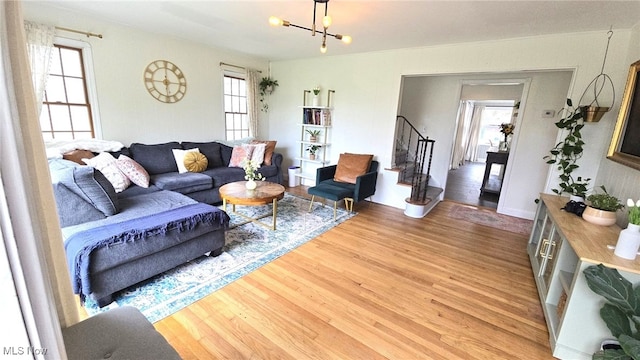22322 Westwood Rd, Fairview Park, OH 44126 - living room featuring a notable chandelier, wood finished floors, and stairway