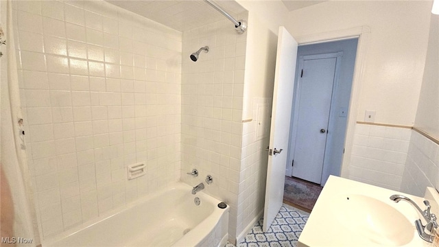 22322 Westwood Rd, Fairview Park, OH 44126 - bathroom with a sink, tile walls, wainscoting, and tub / shower combination