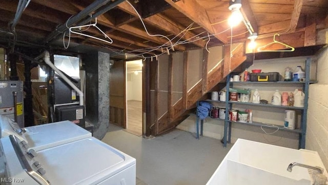 22322 Westwood Rd, Fairview Park, OH 44126 - unfinished below grade area with heating unit, gas water heater, a sink, and washing machine and clothes dryer