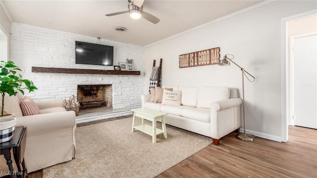 5130 Bateson Dr NE, Thornville, OH 43076 - living room with wood finished floors, visible vents, a fireplace, ceiling fan, and baseboards