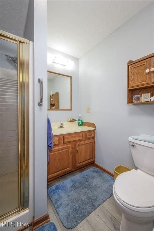 4561 Industry Rd, Ravenna, OH 44266 - full bathroom with vanity, baseboards, a stall shower, and toilet